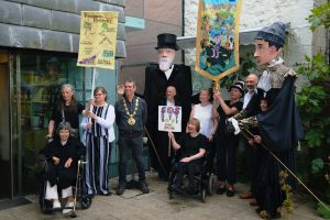 Image shows Shalla Arts group at Newlyn Art Gallery with Passmore edwards pupets and banners