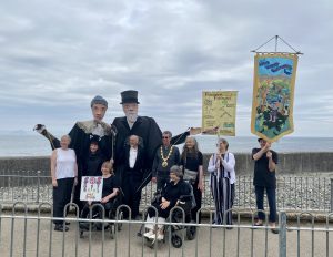 Image shows Shalla Arts group at Newlyn Art Gallery with Passmore edwards pupets and banners