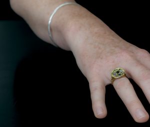 Hand modelling Dwynwen Ring with Ruby and Tourmaline on black background