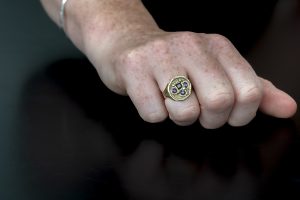 Hand modelling Dwynwen Ring with Ruby and Tourmaline on black background