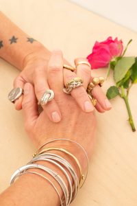 Two hands modelling Handmade jewellery designed and crafted in Dorset UK. HOUSE OF AQUILA