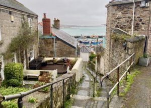 Image shows steps leading down between the houses, towards Newlyn harbour