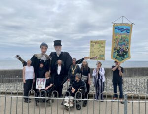 Image shows Shalla Arts group at Newlyn Art Gallery with Passmore edwards pupets and banners