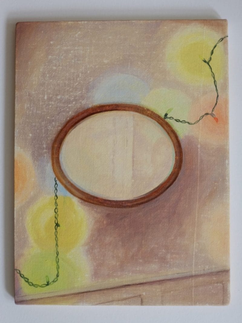Beth Kaye - Glowing is a painting with a wooden oval frame on a textured background, featuring blurred yellow circles and a looping green string, creating a soft, dreamy atmosphere.