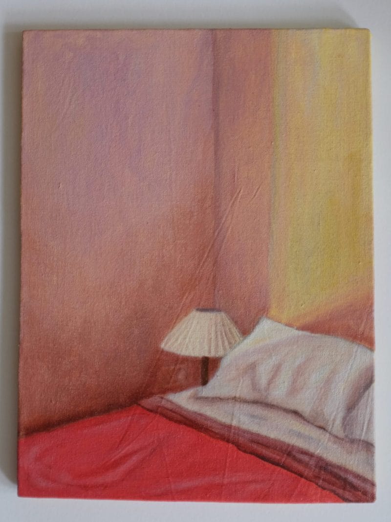 Beth Kaye - Just Us: A painting featuring a bed with white pillows, red covers, and a small lamp against softly lit pink and yellow walls.