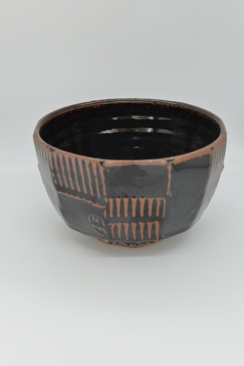 dark ceramic bowl with striped textured detail