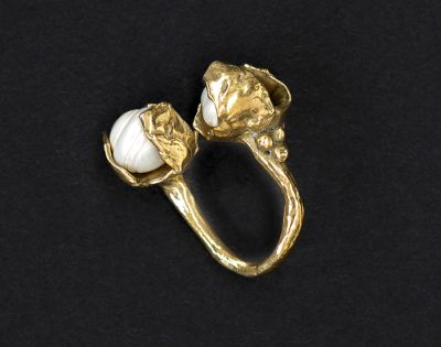 Brass ring with two pearls.