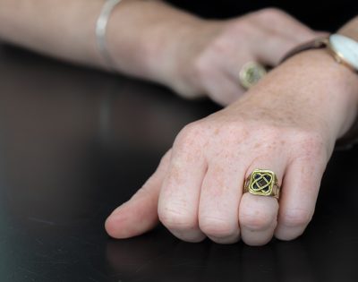 Hand modelling Sonnet Ring with Sapphire & Tourmaline on black background