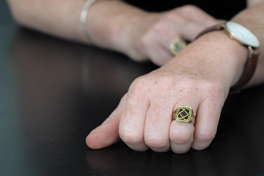 Hand modelling Sonnet Ring with Sapphire & Tourmaline on black background