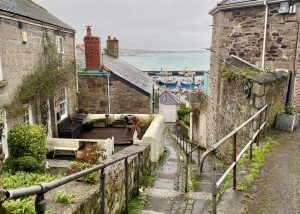 Image shows steps leading down between the houses, towards Newlyn harbour
