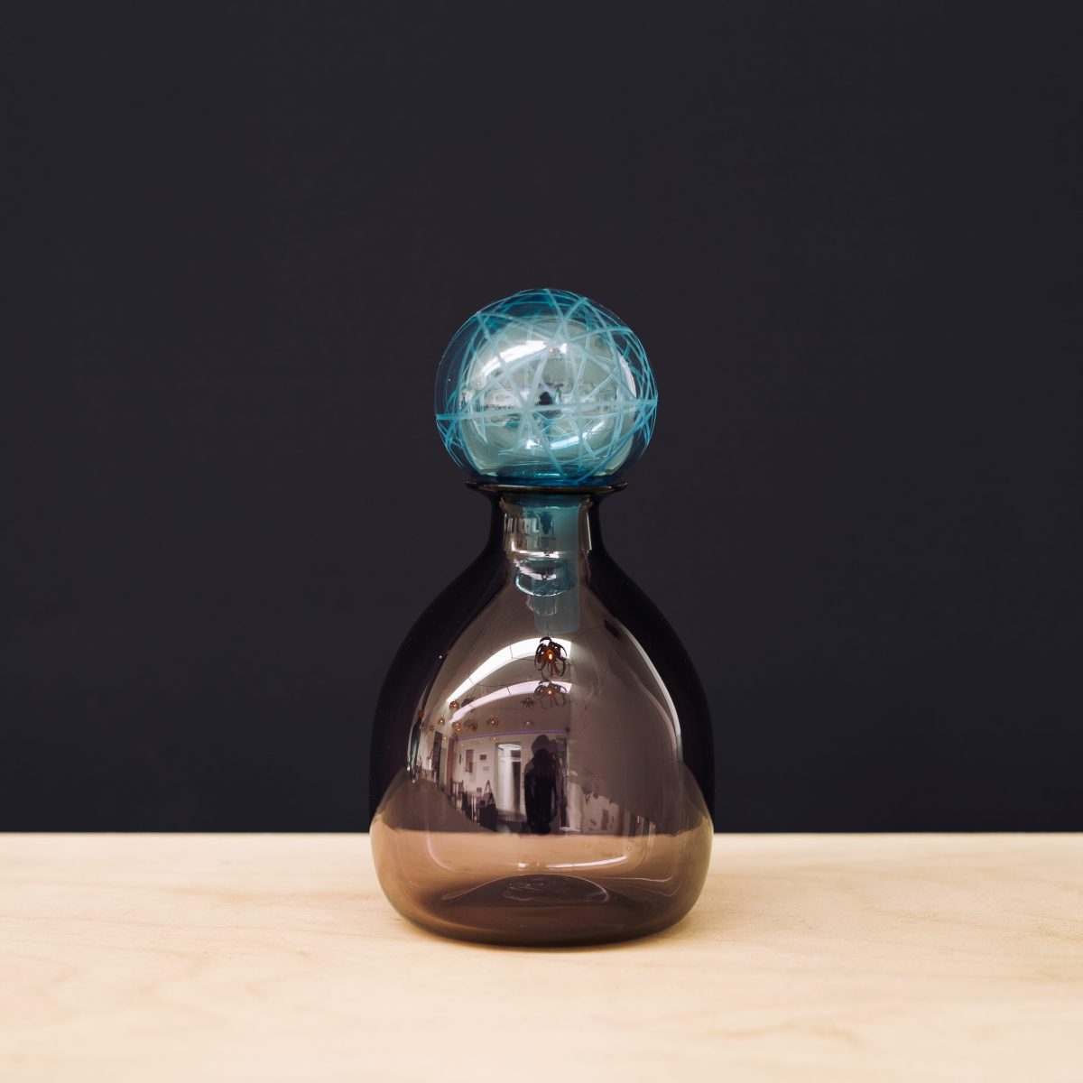 Brown carafe with blue stopper