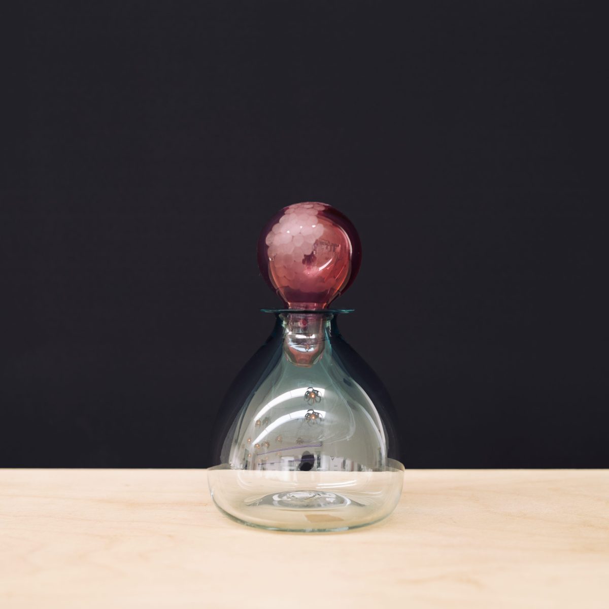 Clear carafe with red stopper