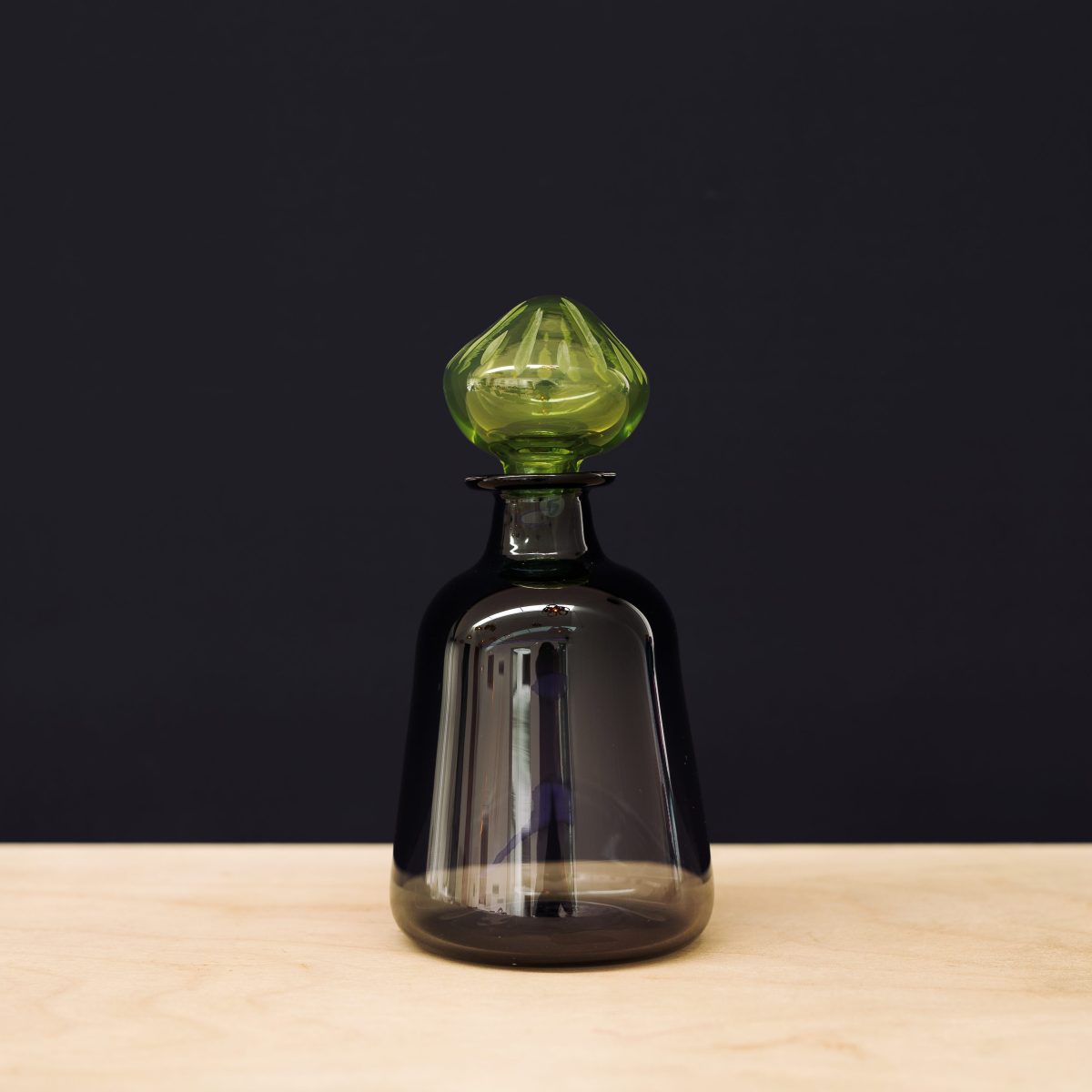 Black carafe with green stopper